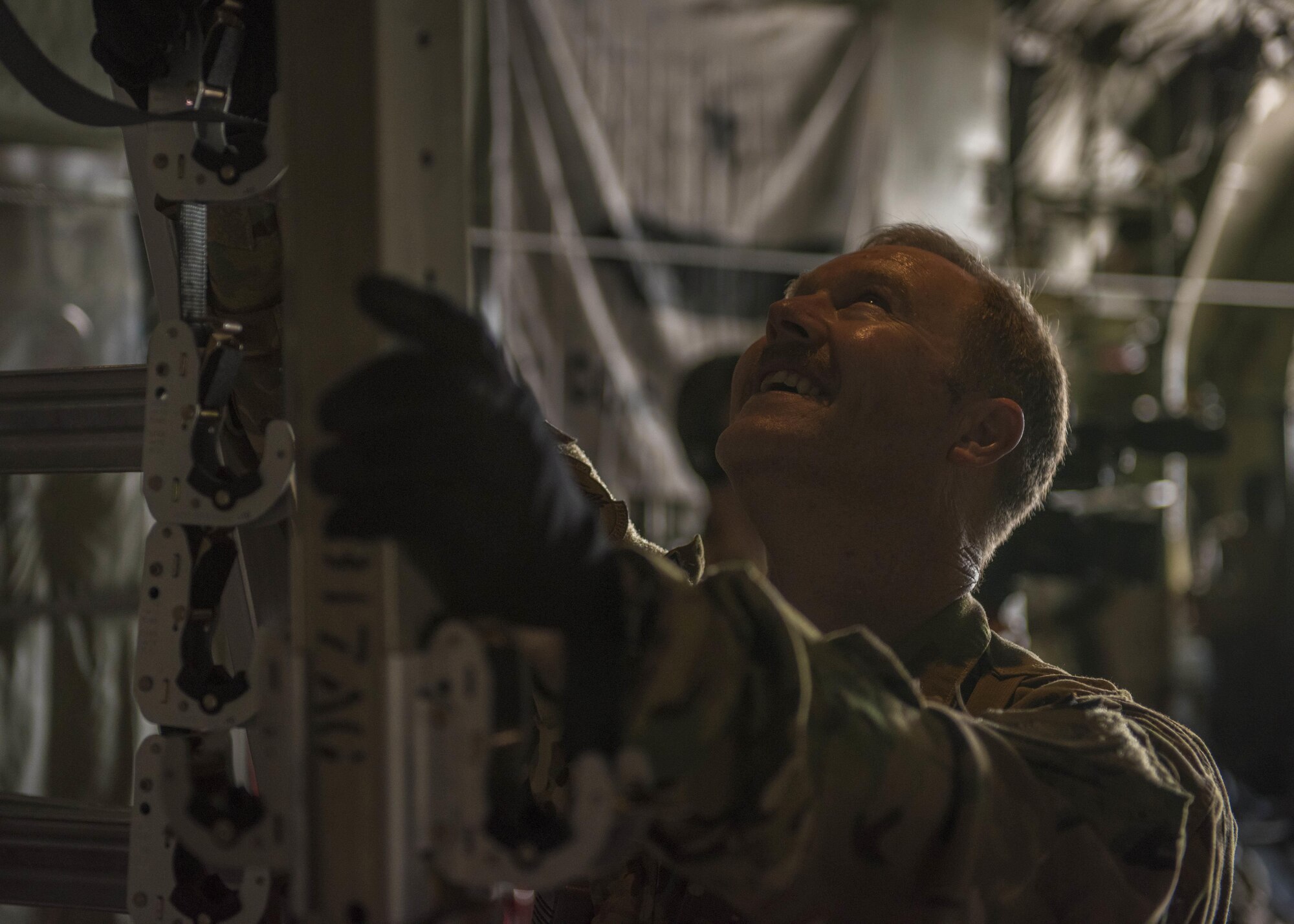 Chief Master Sgt. Randel White, 455th Expeditionary Aeromedical Evacuation Squadron, holds a ladder steady on a C-130J Super Hercules at Bagram Airfield, Afghanistan, May 05, 2016. The 455th EAES are on call and remain ready to transport patients at a moments notice. (U.S. Air Force photo by Senior Airman Justyn M. Freeman)