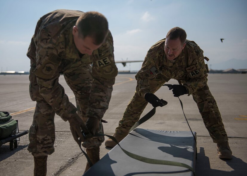 Members of the 455th Expeditionary Aeromedical Evacuation Squadron, put the medical stretcher straps together to be loaded onto the C-130J Super Hercules at Bagram Airfield, Afghanistan, May 05, 2016. If servicemembers must be moved from the battlefield to a medical facility outside of Afghanistan, the airmen assigned to the 455th EAES will be the link between them getting from the combat zone to higher-level medical care. (U.S. Air Force photo by Senior Airman Justyn M. Freeman)