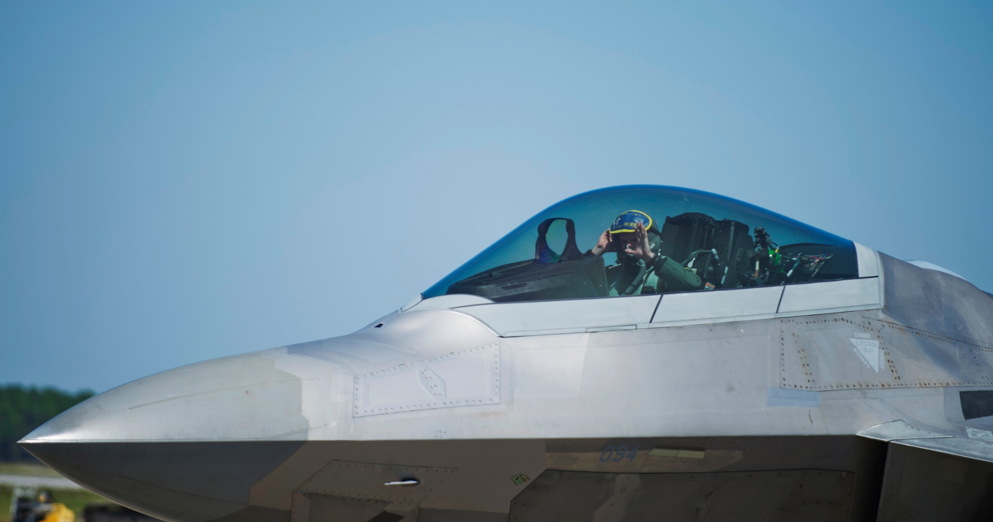 An F-22 Raptor pilot with the 95th Fighter Squadron, Tyndall Air Force Base, Fla., waves as he taxis by May 8, 2016 on the Tyndall AFB flightline. The 95th FS spent just under a month in Europe during a deployment called Rapid Raptor. (U.S. Air Force photo by Senior Airman Dustin Mullen/Released)