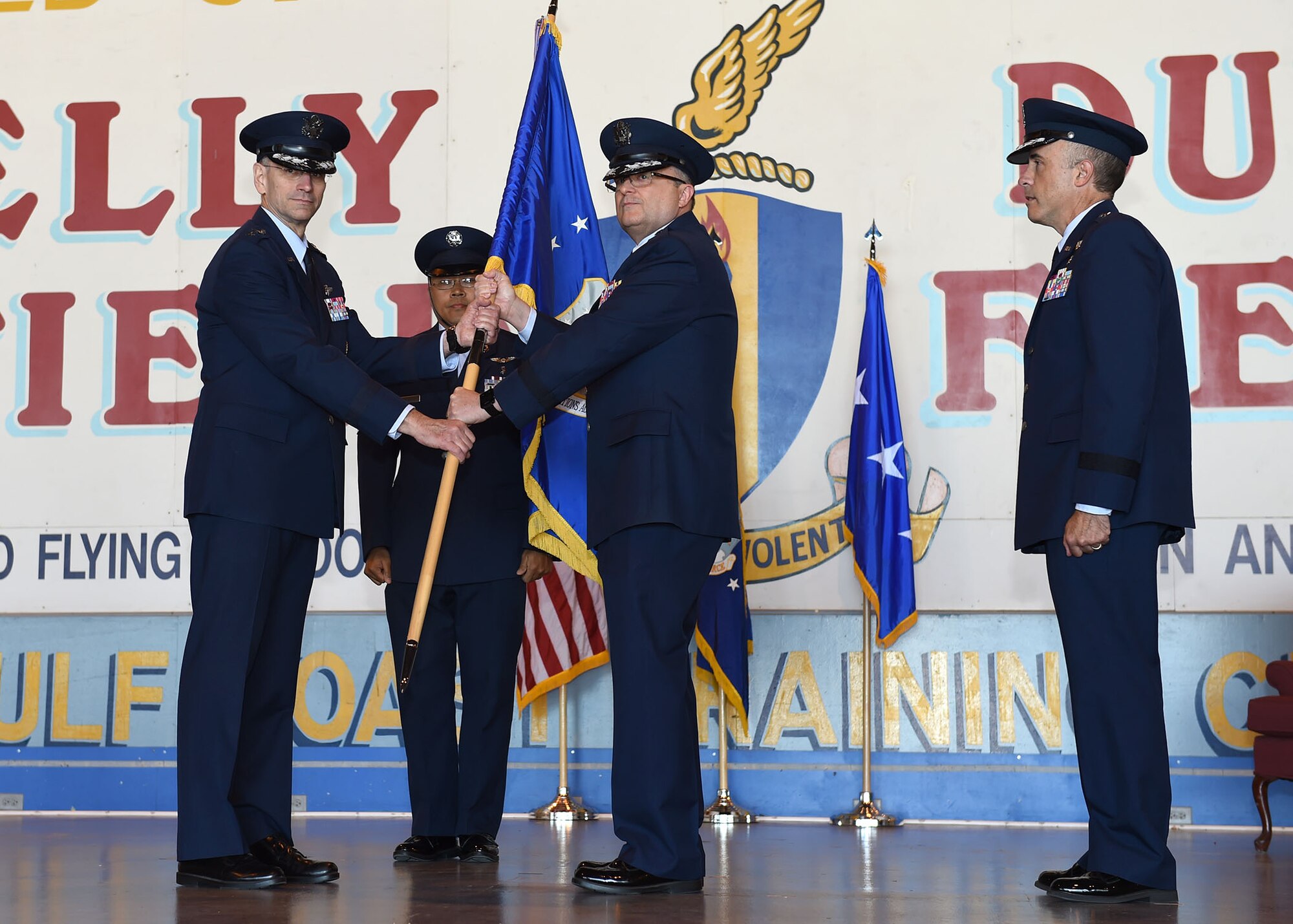 Lt. Gen. Mark A. Ediger (left), Surgeon General of the Air Force, receives the Air Force Medical Operations Agency guidon from Brig. Gen. Lee E. Payne (center), former AFMOA commander, during a May 6 change of command ceremony at Port San Antonio. In military tradition, the passing of a unit’s guidon signifies relinquishing or accepting command of that unit. 