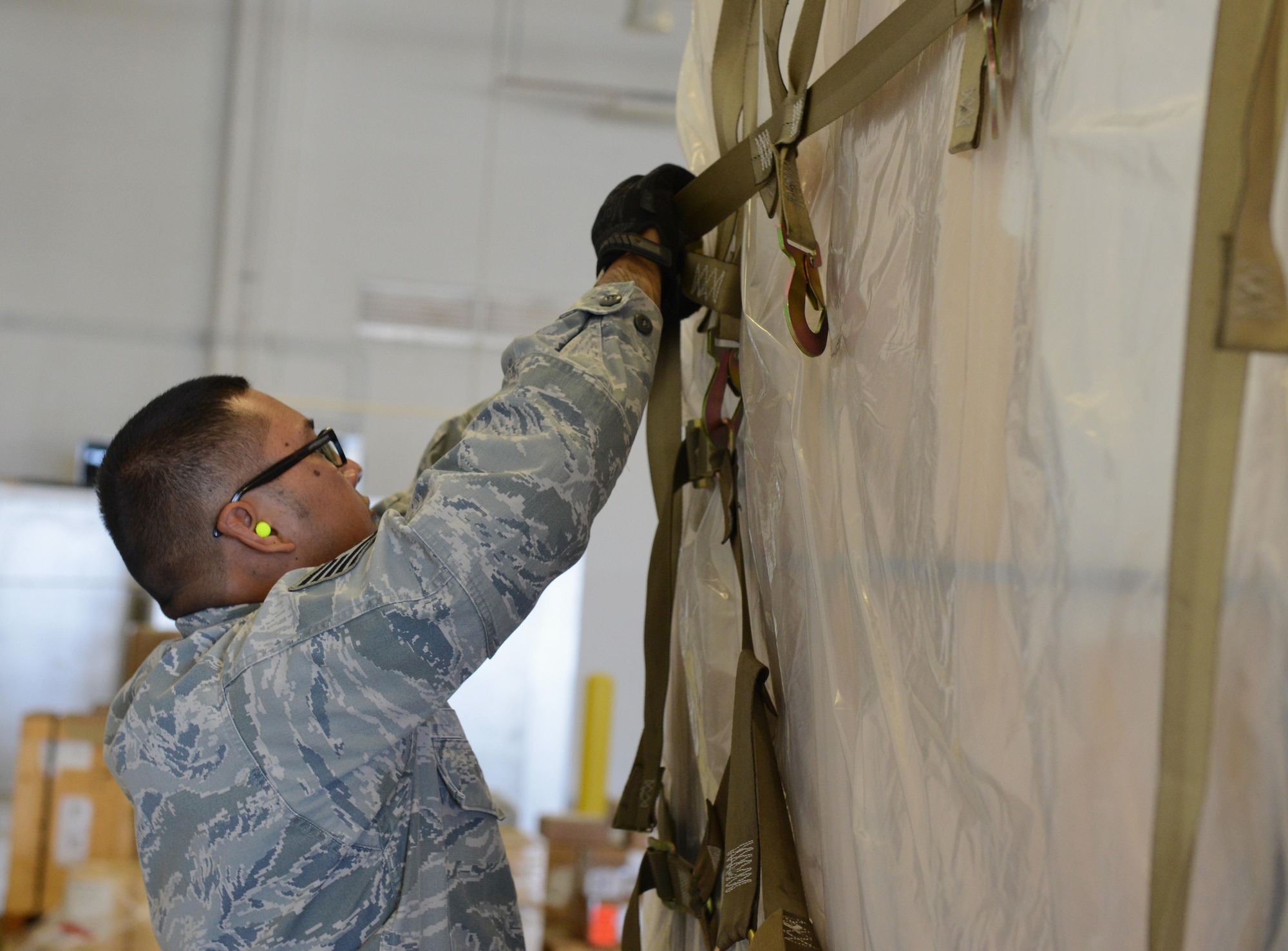 Tech. Sgt. Rolando Jose, 44th Aerial Port Squadron air transportation special handler, breaks down a cargo pallet May 2, 2016, at Andersen Air Force Base, Guam. Jose serves in the U.S. Air Force Reserve and works in a civilian capacity at Antonio B. Won Pat International Airport as a Transportation Security Administration agent. (U.S. Air Force photo by Airman 1st Class Arielle Vasquez/Released)