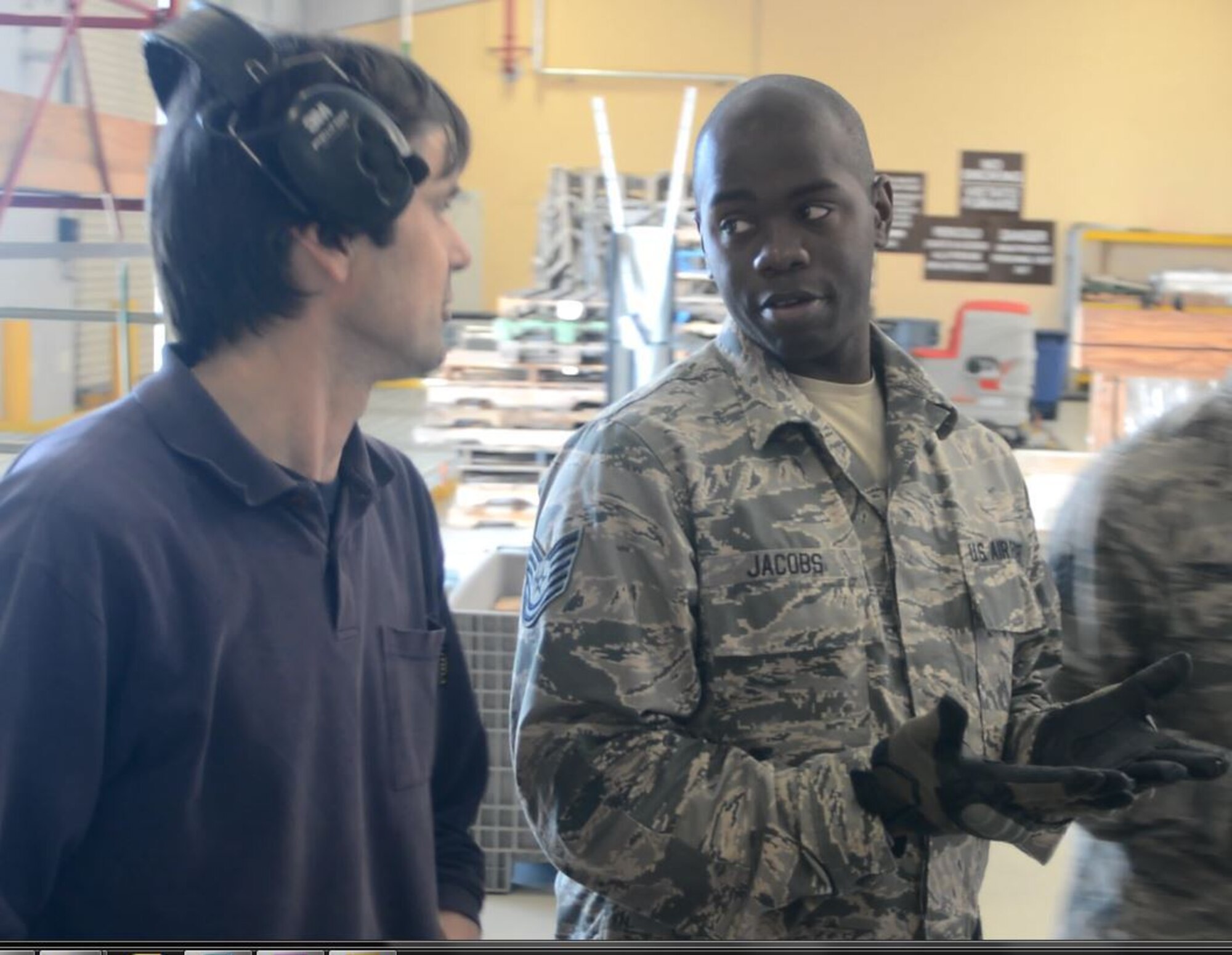 Tech. Sgt. William Jacobs (right), 71st Aerial Port Squadron, asks questions to Roberto Zanot, heavy equipment operator, about his process for building air cargo pallets May 4, 2016, at Aviano Air Base, Italy.  Jacobs, whose squadron is a geographically separated unit from the 512th Airlift Wing in Dover, Delaware, is participating in a hands-on training exercise at the NATO base that employs approximately 70 active-duty Airmen and Italian local nationals, like Zanot, who work together to service aircraft, passengers and cargo transiting in and out of the air terminal operations. (U.S. Air Force photo/Staff Sgt. Joe Yanik)