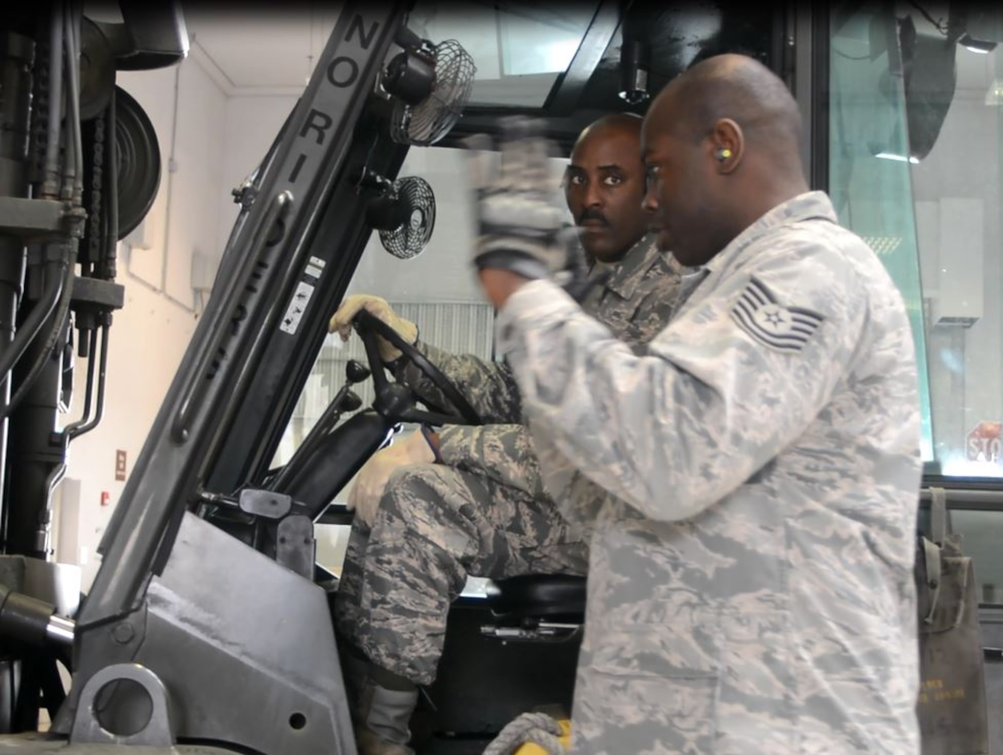 Working as a team, Tech. Sgt. William Jacobs (foreground) and Staff Sgt. Malcolm Jenkins, 71st Aerial Port Squadron, use a "10k Standard" forklift to prepare cargo pallets for loading onto departing aircraft May 4, 2016 at Aviano Air Base, Italy. The two reservists, whose squadron is located at Joint Base Langley-Eustis, Va., are participating in a hands-on training exercise at the NATO base's small air terminal. (U.S. Air Force photo/Staff Sgt. Joe Yanik)