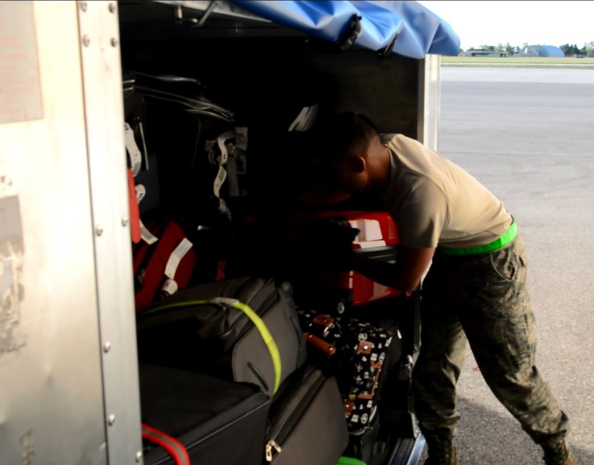 Senior Airman Andrew Castro, 71st Aerial Port Squadron, loads a luggage bin assigned to a departing aircraft May 4, 2016, at Aviano Air Base, Italy. Castro, who typically works in aircraft load planning, is participating in a training exercise designed to expose 71st APS Airmen to multiple areas of air terminal operations. (U.S. Air Force photo/Staff Sgt. Joe Yanik)