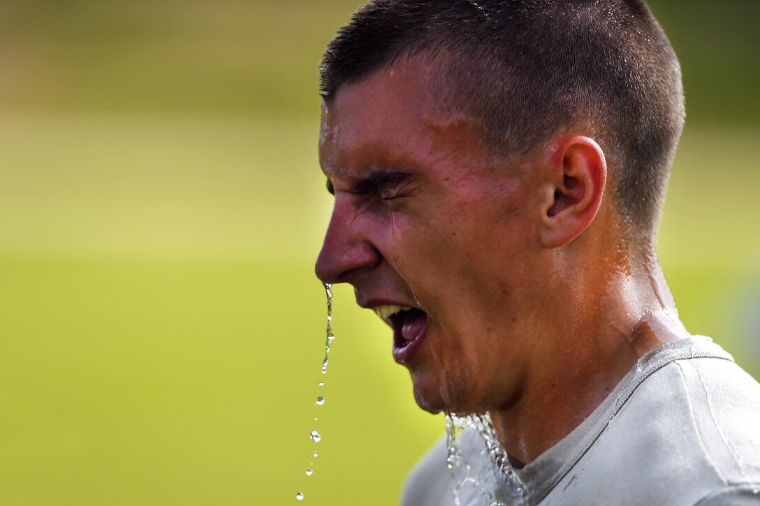 Army Pfc. Phillip Hill reacts after a fellow tank crew member doused his head with water following a physical fitness event during the Gen. Gordon Sullivan Cup best tank crew competition at Fort Benning, Ga., May 1, 2016. Hill is assigned to the North Carolina Army National Guard’s Company C, 1st Battalion, 252nd Armor Regiment. Army photo by Sgt. 1st Class Jon Soucy