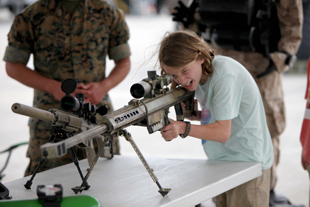 An air show patron looks down the scope of an M40A5 Sniper Rifle during the 2016 MCAS Cherry Point Air Show --  "Celebrating 75 Years" at Marine Corps Air Station Cherry Point, N.C., April 29, 30 and May 1, 2016. This years air show celebrated the 75th anniversary of 2nd Marine Aircraft Wing and MCAS Cherry Point and featured 40 static displays and 17 aerial performers. 