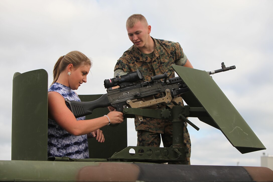 A Marine describes the functions of a weapon to an air show patron during the 2016 MCAS Cherry Point Air Show --  "Celebrating 75 Years" at Marine Corps Air Station Cherry Point, N.C., April 29, 30 and May 1, 2016. This years air show celebrated the 75th anniversary of 2nd Marine Aircraft Wing and MCAS Cherry Point and featured 40 static displays and 17 aerial performers. 