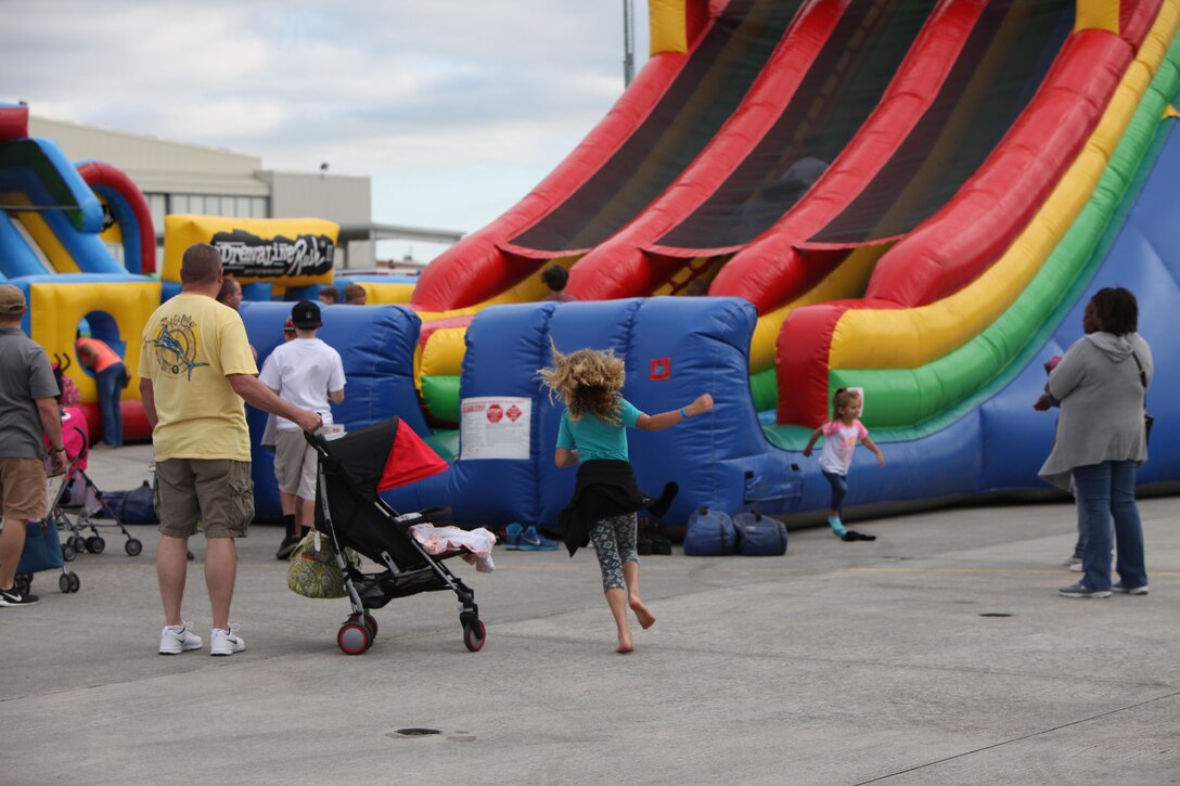 Children play on bouncy houses and rock walls in the kid zone at the 2016 MCAS Cherry Point Air Show – “Celebrating 75 Years” at Marine Corps Air Station Cherry Point, N.C., April 29, 2016. This year’s air show celebrated MCAS Cherry Point and 2nd Marine Aircraft Wing’s 75th anniversaries and featured 40 static displays, 17 aerial performers and a concert.