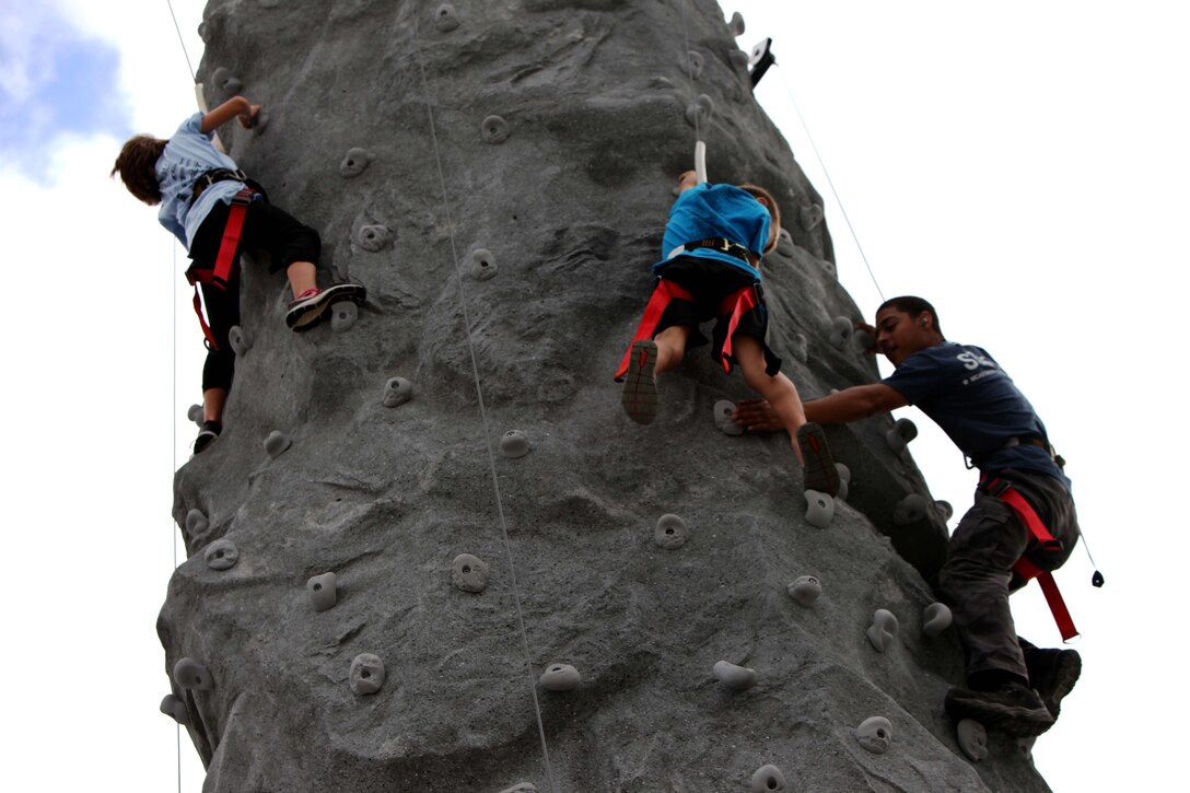 Children climb on rock walls in the kid zone at the 2016 MCAS Cherry Point Air Show – “Celebrating 75 Years” at Marine Corps Air Station Cherry Point, N.C., April 29, 2016. This year’s air show celebrated MCAS Cherry Point and 2nd Marine Aircraft Wing’s 75th anniversaries and featured 40 static displays, 17 aerial performers and a concert.