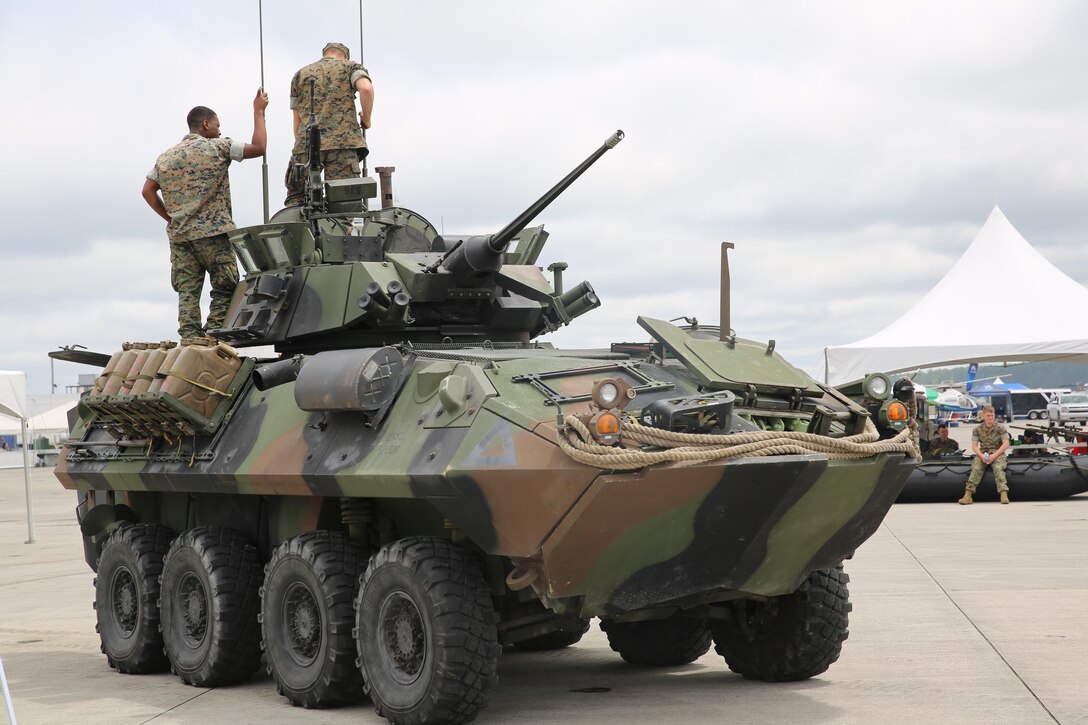 Marines stand atop a Light Armored Vehicle display at the 2016 Marine Corps Air Station Cherry Point Air Show – “Celebrating 75 Years” at MCAS Cherry Point, N.C., April 29, 2016. The MTVR Armor LAV System has a highly survivable armor package and off-road mission profile and brings needed supplies and Marines to the fight, fast, no matter the conflicting environment. This is our biggest air show ever with more performers and more flight line displays celebrating MCAS Cherry Point and 2nd Marine Aircraft Wing’s 75th anniversary. (U.S. Marine Corps photo by Lance Cpl. Mackenzie Gibson/ Released)