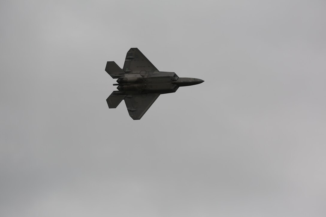 A U.S. Air Force F-22 Raptor rumbles the ground and amazes airshow patrons at the 2016 Marine Corps Air Station Cherry Point Air Show – “Celebrating 75 Years” at MCAS Cherry Point, N.C., April 29, 2016. The Air Force’s F-22 Raptor combines sensor capabilities with integrated avionics, situational awareness and weapons to provide the first-kill opportunity against threats by performing air-to-air and air-to-ground missions. This year’s air show celebrated MCAS Cherry Point and 2nd Marine Aircraft Wing’s 75th anniversary and featured 40 static displays, 17 aerial performers, as well as a concert. (U.S. Marine Corps photo by Lance Cpl. Mackenzie Gibson/Released)
