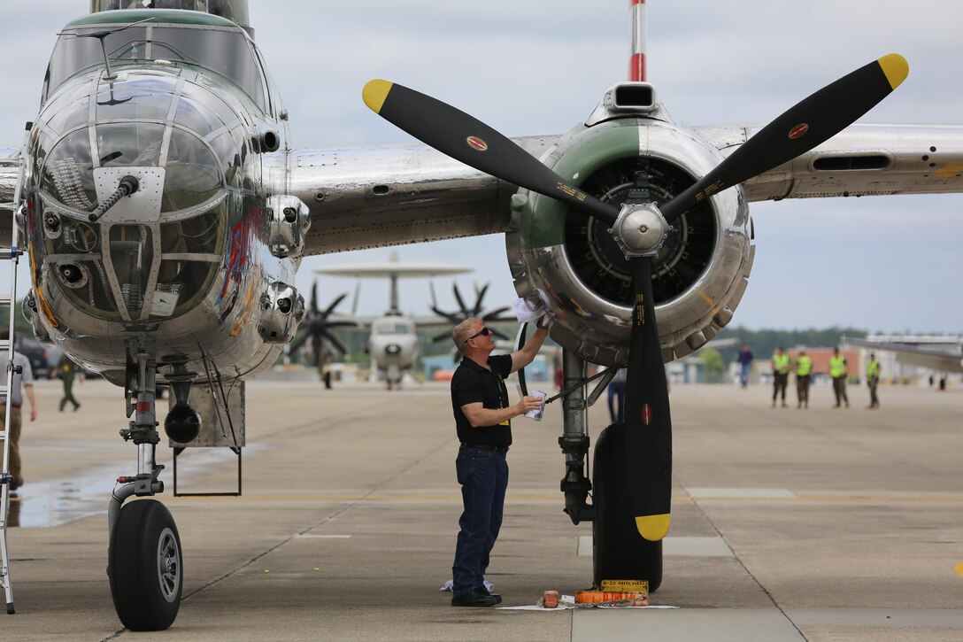 Paul Nuwer, the pilot for the B-52 Bomber "Panchito", cleans his plane on the flight line at the 2016 Marine Corps Air Station Cherry Point Air Show -- "Celebrating 75 Years" at MCAS Cherry Point, N.C., April 29, 2016. The North American B25 was among the famous twin engine medium bombers used during World War II. (U.S. Marine Corps photo by Lance Cpl. Mackenzie Gibson/ Released)