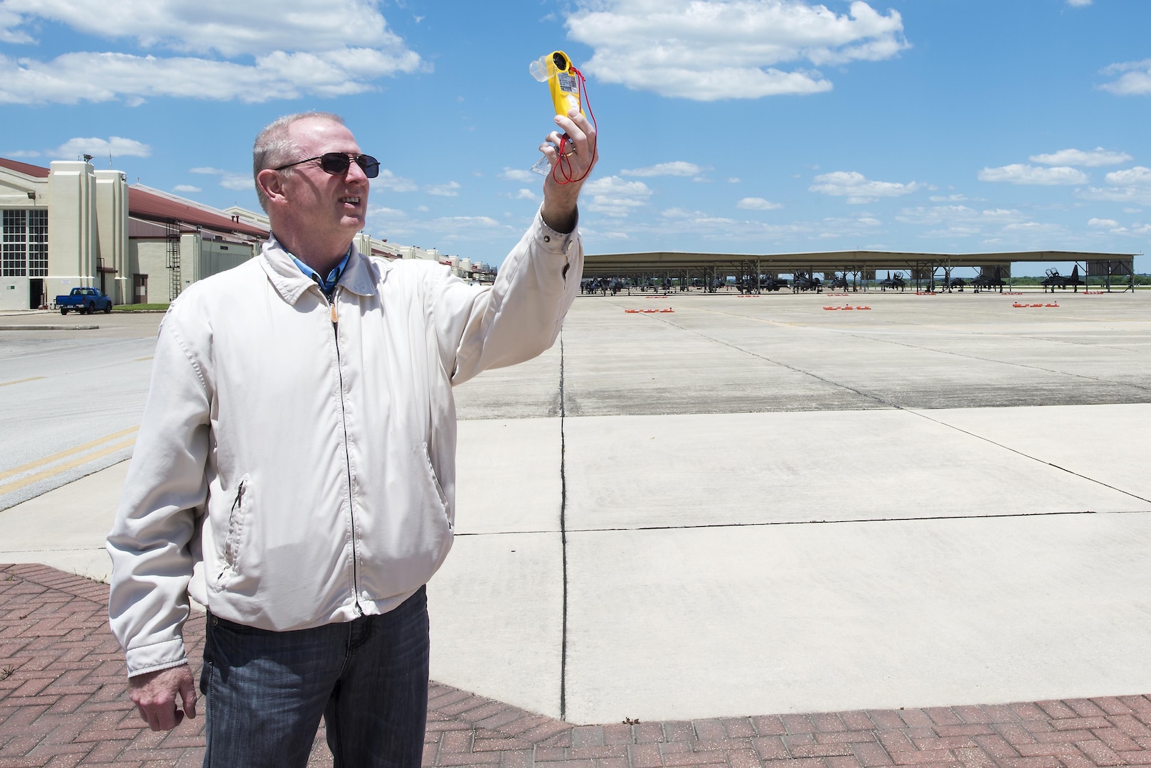 Terry Roberts, 12th Operations Support Squadron weather operations technician, surveys a Kestrel to check wind speeds on the east flightline at Joint Base San Antonio-Randolph May 4, 2016. A Kestrel is a manual way to gather wind information when there is an outage to the primary weather data sensors. 