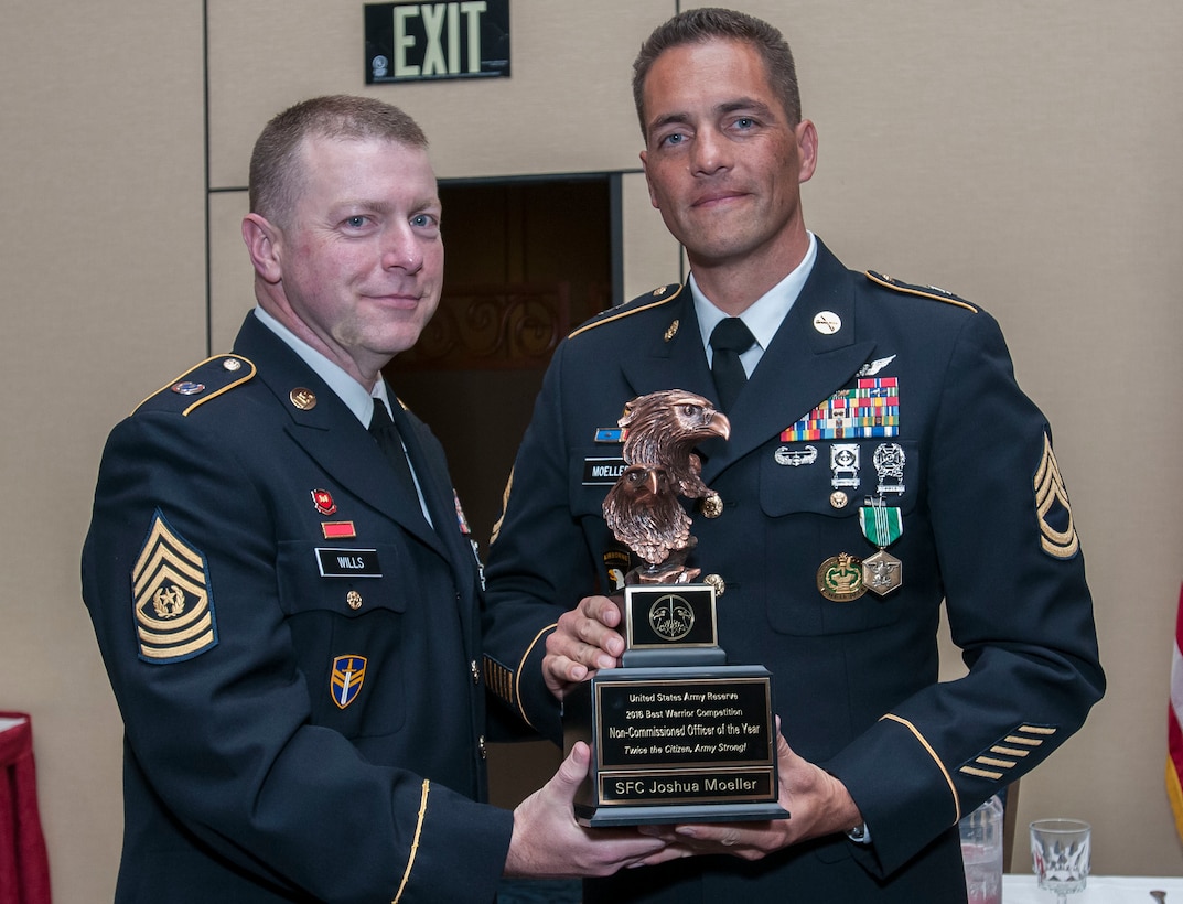 Sgt. 1st Class Joshua Moeller, a drill sergeant with the 108th Training Command (IET) and the 2016 U.S. Army Reserve Noncommissioned Officer of the Year, stands with the USAR Interim Command Sgt. Maj. James P. Wills at the awards banquet May 6. The 2016 USAR BWC held May 2-4 at Fort Bragg, N.C., determined the top noncommissioned officer and junior enlisted Soldier to represent the U.S. Army Reserve in the Department of the Army Best Warrior Competition later this year at Fort A.P. Hill, Va. (U.S. Army photo by Sgt. Darryl Montgomery) (Released)