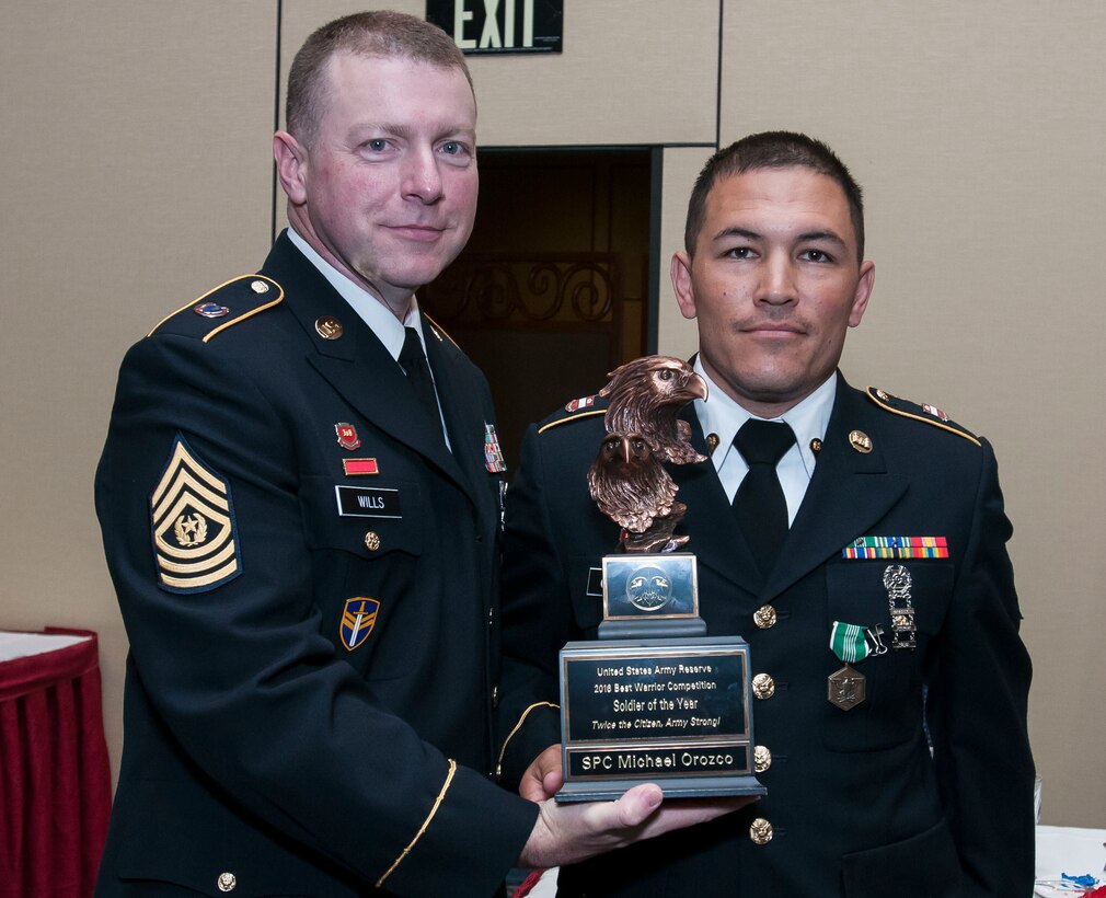 Spc. Michael Orozco, 416th Theater Engineer Command and the 2016 U.S. Army Reserve Soldier of the Year, stands with the USAR Interim Command Sgt. Maj. James P. Wills at the awards banquet May 6. The 2016 USAR BWC held May 2-4 at Fort Bragg, N.C., determined the top noncommissioned officer and junior enlisted Soldier to represent the U.S. Army Reserve in the Department of the Army Best Warrior Competition later this year at Fort A.P. Hill, Va. (U.S. Army photo by Sgt. Darryl Montgomery) (Released)