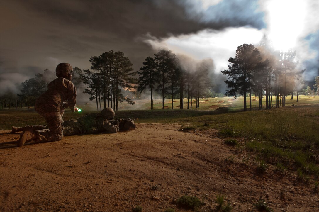 A 2016 U.S. Army Reserve Best Warrior competitor fires downrange at the 50-meter pop up target while pyrotechnics light up the night sky during the M4 carbine qualification portion of the competition at Fort Bragg, N.C., May 4. This year’s Best Warrior Competition will determine the top noncommissioned officer and junior enlisted Soldier who will represent the U.S. Army Reserve in the Department of the Army Best Warrior Competition later this year at Fort A.P. Hill, Va. (U.S. Army photo by Sgt. Christina M. Dion / Released)