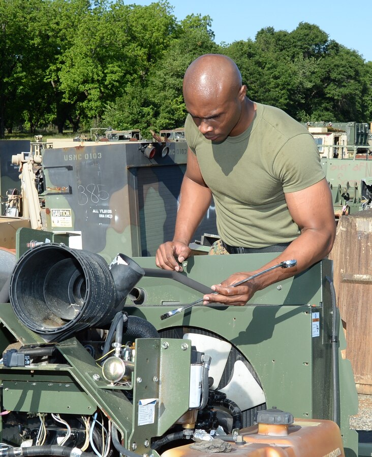 Sgt. Frederick Graham, heavy equipment engineer maintenance chief, Organic Maintenance Unit, Marine Corps Logistics Command, removes reusable parts from scrapped equipment for shipment to installations around the Marine Corps. Graham said some of the parts may be requested for use by other branches of service as well. The sergeant, who was recently selected as LOGCOM’s Noncommissioned Officer of the Quarter, said one of the highlights of his military career was meeting one of the original Montford Point Marines, Henry L. Jackson, a World War II veteran and retired U.S. Air Force master sergeant. Jackson, a Congressional Gold Medal recipient, was one of the 20,000 African-American Marines to attend basic training at Montford Point, North Carolina, between 1942 and 1949.

