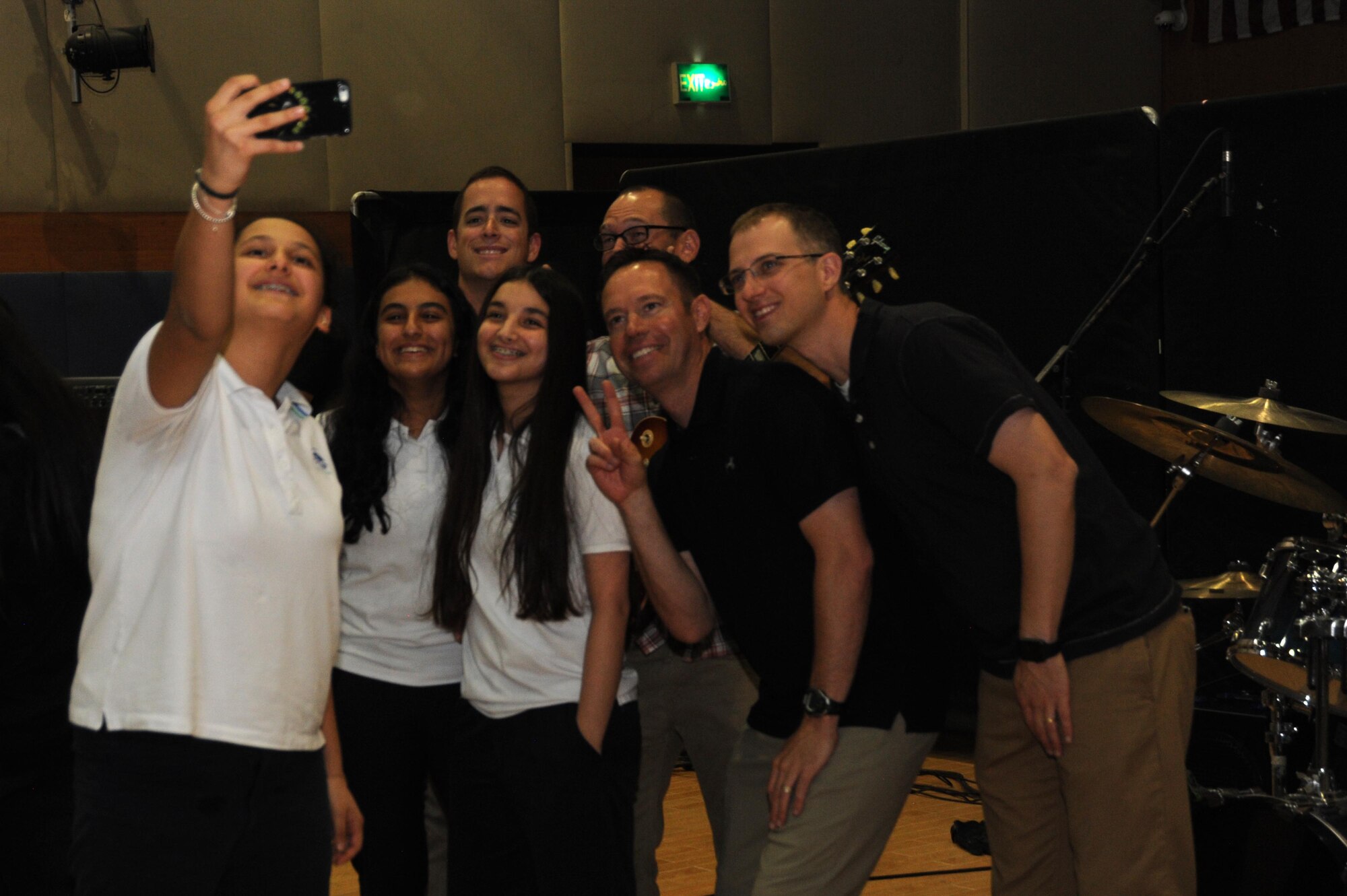Members of the Air Force Central Command Galaxy band take a selfie with students from a local school in Southwest Asia, May 2, 2016. Establishing relationships and getting involved with the local community is a major part of the mission for the AFCENT Band. (U.S. Air Force photo by Senior Airman Zachary Kee)