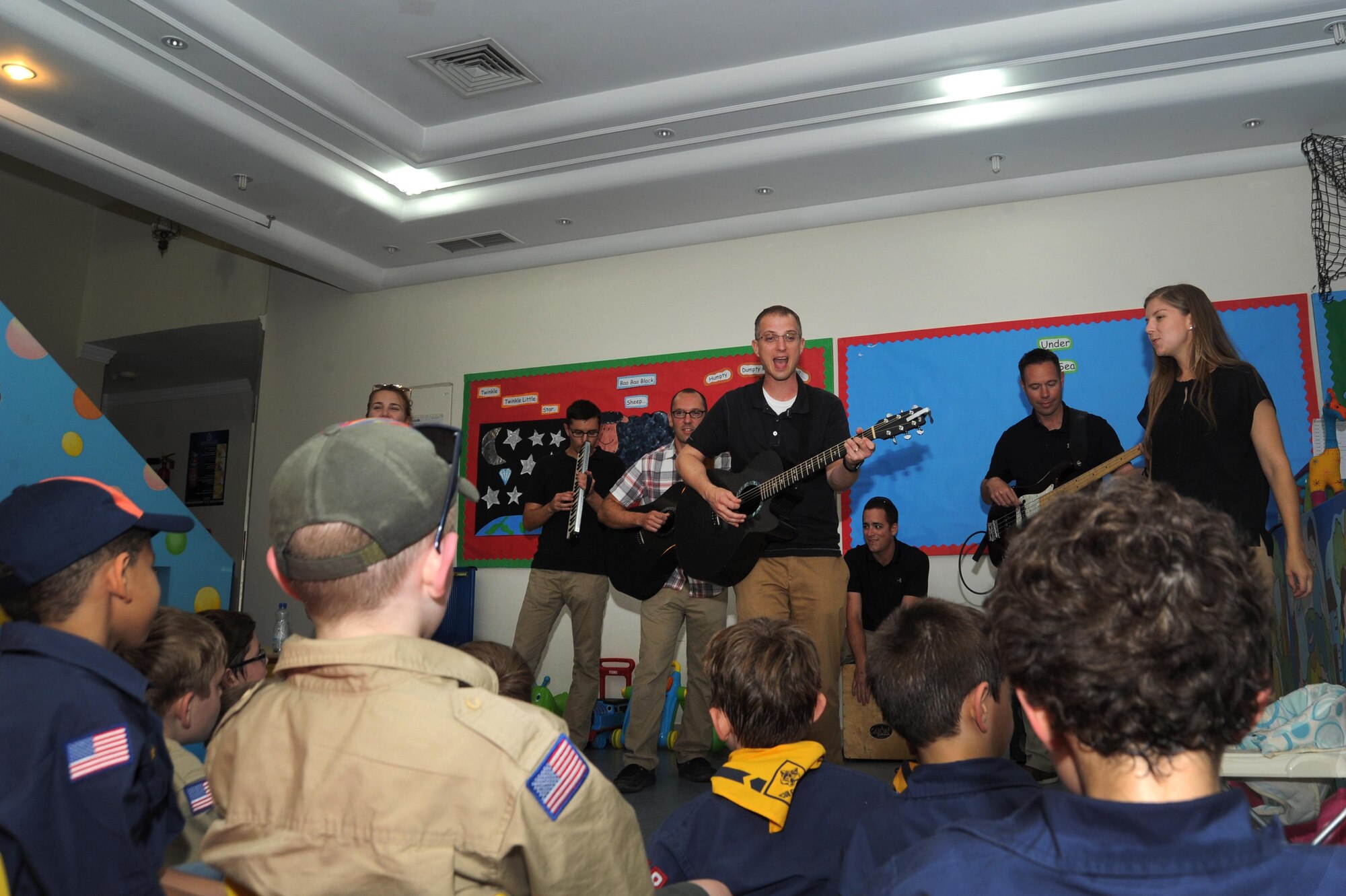 Tech Sgt. Clinton Whitney, Air Force Central Command Galaxy band vocalist and acoustic guitar player, performs with his fellow bandsmen for a local Boy Scout troop May 2, 2016 in Southwest Asia.  After the performance, the scouts were able to ask the musicians several questions on what it’s like to be a member of the AFCENT Band. (U.S. Air Force photo by Senior Airman Zachary Kee)