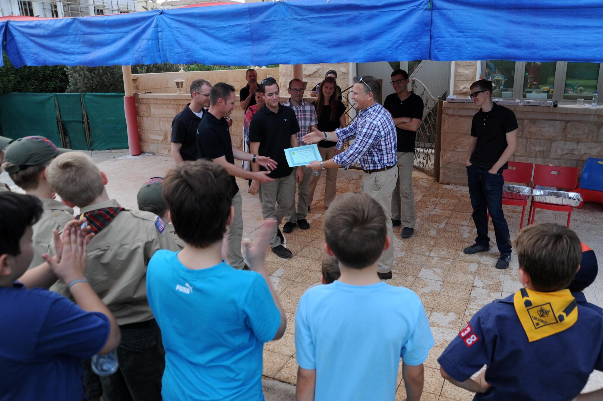 Members of the Air Force Central Command Galaxy band receive a certificate of appreciation from a local Boy Scout troop May 2, 2016 at an undisclosed location in Southwest Asia. The AFCENT band uses the universal language of music in their performances to reach out and make lasting impressions on each of their audiences. (U.S. Air Force photo by Senior Airman Zachary Kee)