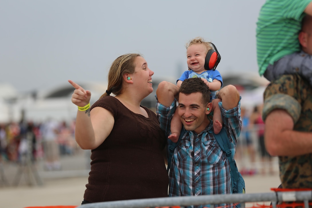 A family enjoys watching the U.S. Navy Blue Angels perform at the 2016 Marine Corps Air Station Cherry Point Air Show – “Celebrating 75 Years” at MCAS Cherry Point, N.C., May 1, 2016. This year’s air show celebrated MCAS Cherry Point and 2nd Marine Aircraft Wing’s 75th anniversaries and featured 40 static displays, 17 aerial performers and a concert. (U.S. Marine Corps photo by Lance Cpl. Mackenzie Gibson/ Released)
