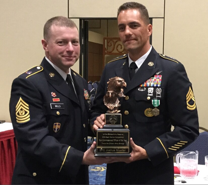 Sgt. 1st Class Joshua Moeller, right, representing the 108th Training Command (Initial Entry Training), accepts the Noncommissioned Officer of the Year trophy from Command Sgt. Maj. James P. Wills, interim command sergeant major of the U.S. Army Reserve, at the U.S. Army Reserve Best Warrior Competition awards luncheon, May 6, at the Iron Mike Conference Center, Fort Bragg, N.C. Moeller will represent the U.S. Army Reserve at the Army Best Warrior Competition later this year at Fort A.P. Hill, Va. (U.S. Army photo by Timothy L. Hale) (Released)