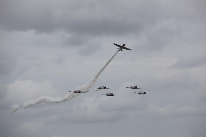 Geico Skytypers prepare to type messages to the crowd at the 2016 Marine Corps Air Station Cherry Point Air Show – “Celebrating 75 Years” at MCAS Cherry Point, N.C., May 1, 2016.
The GEICO Skytypers’ flight squadron of six SNJ-2 aircraft perform precision flight maneuvers. The team of vintage World War II aircraft is known for skytyping the process of emitting biodegradable vapor in a dot matrix pattern, creating a billboard in the sky. This year’s air show celebrated MCAS Cherry Point and 2nd Marine Aircraft Wing’s 75th anniversary and featured 40 static displays, 17 aerial performers with something fun for all ages.
