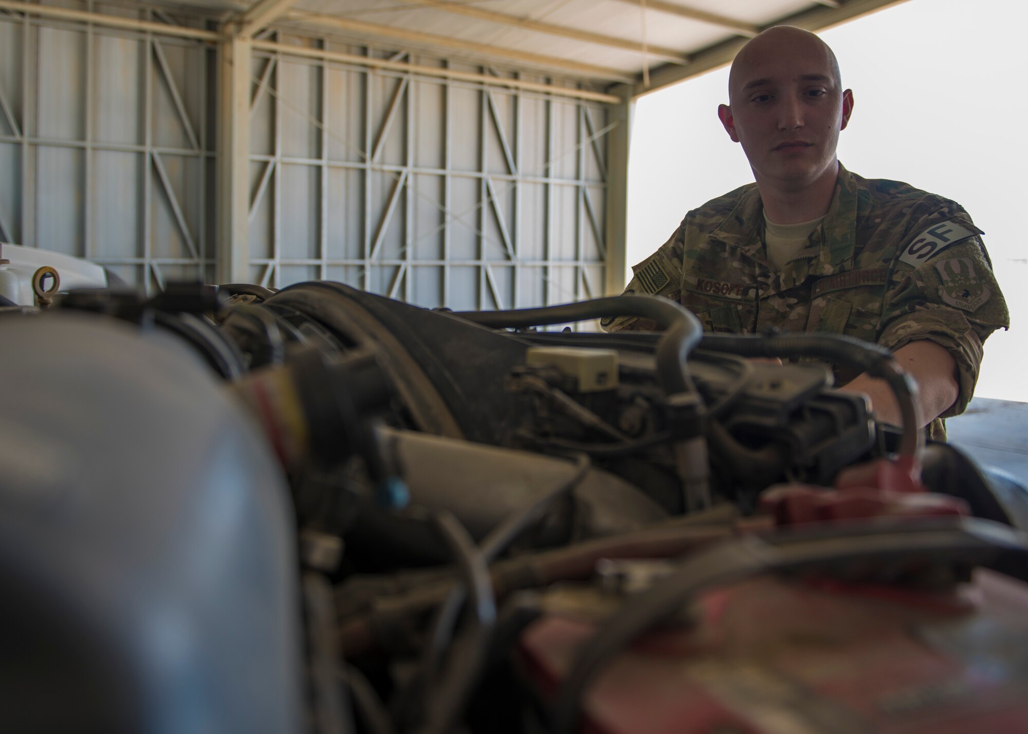 Senior Airman Devlin Kosoff, 451st Expeditionary Support Squadron flightline security, checks the fluids and the truck lines during a change of the guard at Kandahar Airfield, Afghanistan, May 06, 2016. Security Forces members at KAF are responsible for the security of more than 150 aircraft and $2.2 billion of resources. (U.S. Air Force photo by Senior Airman Justyn M. Freeman)
