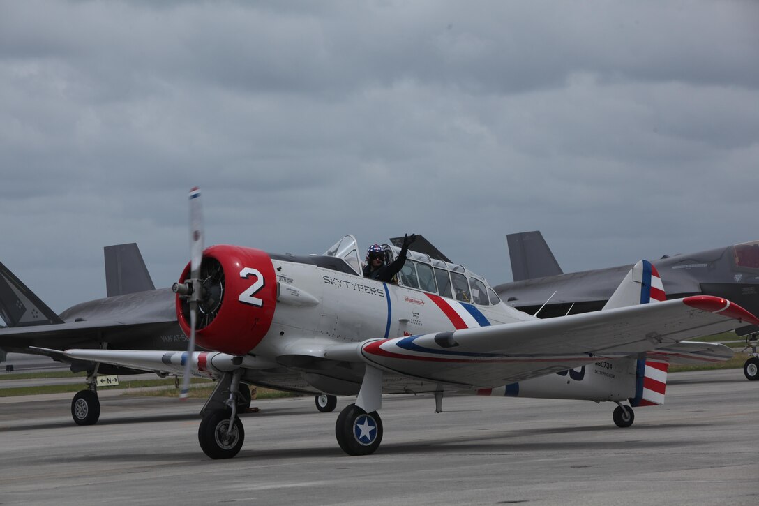 A member of the GEICO Skytypers cruises the flight line after an aerbatic performance at the 2016 Marine Corps Air Station Cherry Point Air Show – “Celebrating 75 Years” at MCAS Cherry Point, N.C., May 1, 2016.
The GEICO Skytypers’ flight squadron of six SNJ-2 aircraft perform precision flight maneuvers. The team of vintage World War II aircraft is known for skytyping the process of emitting biodegradable vapor in a dot matrix pattern, creating a billboard in the sky. This year’s air show celebrated MCAS Cherry Point and 2nd Marine Aircraft Wing’s 75th anniversary and featured 40 static displays, 17 aerial performers with something fun for all ages.
