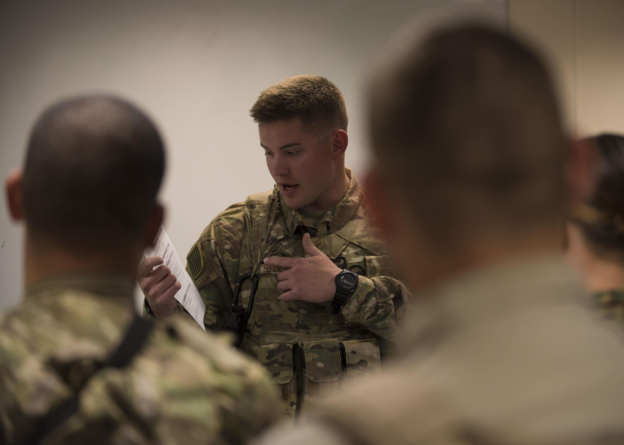 Senior Airman Gunnar Stockdale, 451st Expeditionary Support Squadron flightline security, gives a brief about flight line protocol during a changing of the guard at Kandahar Airfield, Afghanistan, May 06, 2016. Guardmount is an official military function conducted at the start of a Defender's shift and may be used to conduct roll call, announcements, weapons and equipment inspections or post assignments. (U.S. Air Force photo by Senior Airman Justyn M. Freeman)