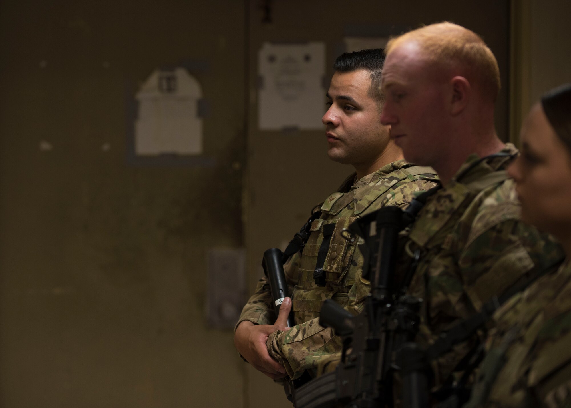 Staff Sgt. Jose Saldana, 451st Expeditionary Support Squadron flightline security, listens in on a brief during the changing of the guard at Kandahar Airfield, Afghanistan, May 06, 2016. Guardmount is an official military function conducted at the start of a Defender's shift and may be used to conduct roll call, announcements, weapons and equipment inspections or post assignments. (U.S. Air Force photo by Senior Airman Justyn M. Freeman)