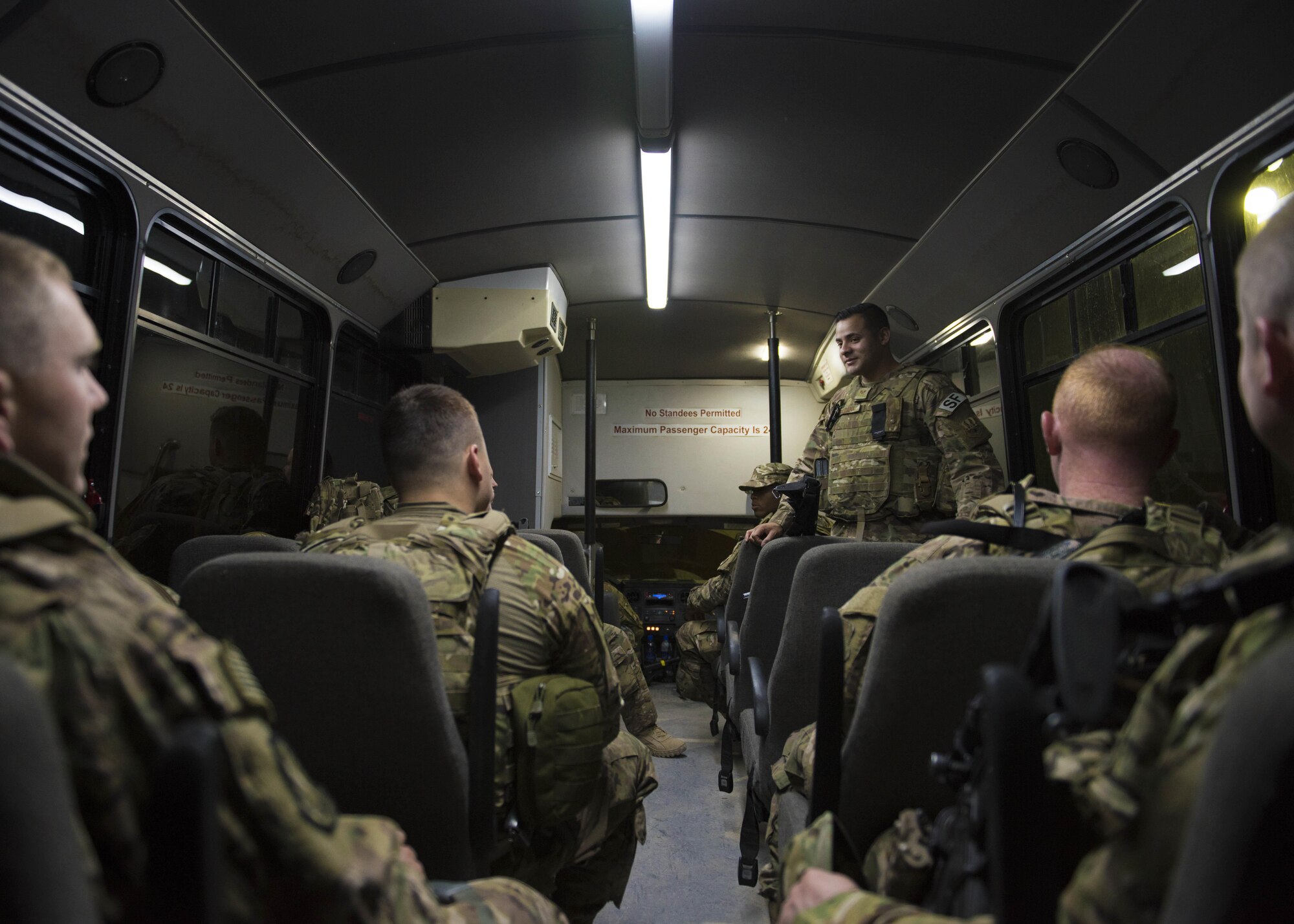 Staff Sgt. Jose Saldana, 451st Expeditionary Support Squadron flightline security, speaks with Airmen who are headed to a change of the guard at Kandahar Airfield, Afghanistan, May 06, 2016. Guardmount is an official military function conducted at the start of a Defender's shift and may be used to conduct roll call, announcements, weapons and equipment inspections or post assignments. (U.S. Air Force photo by Senior Airman Justyn M. Freeman)