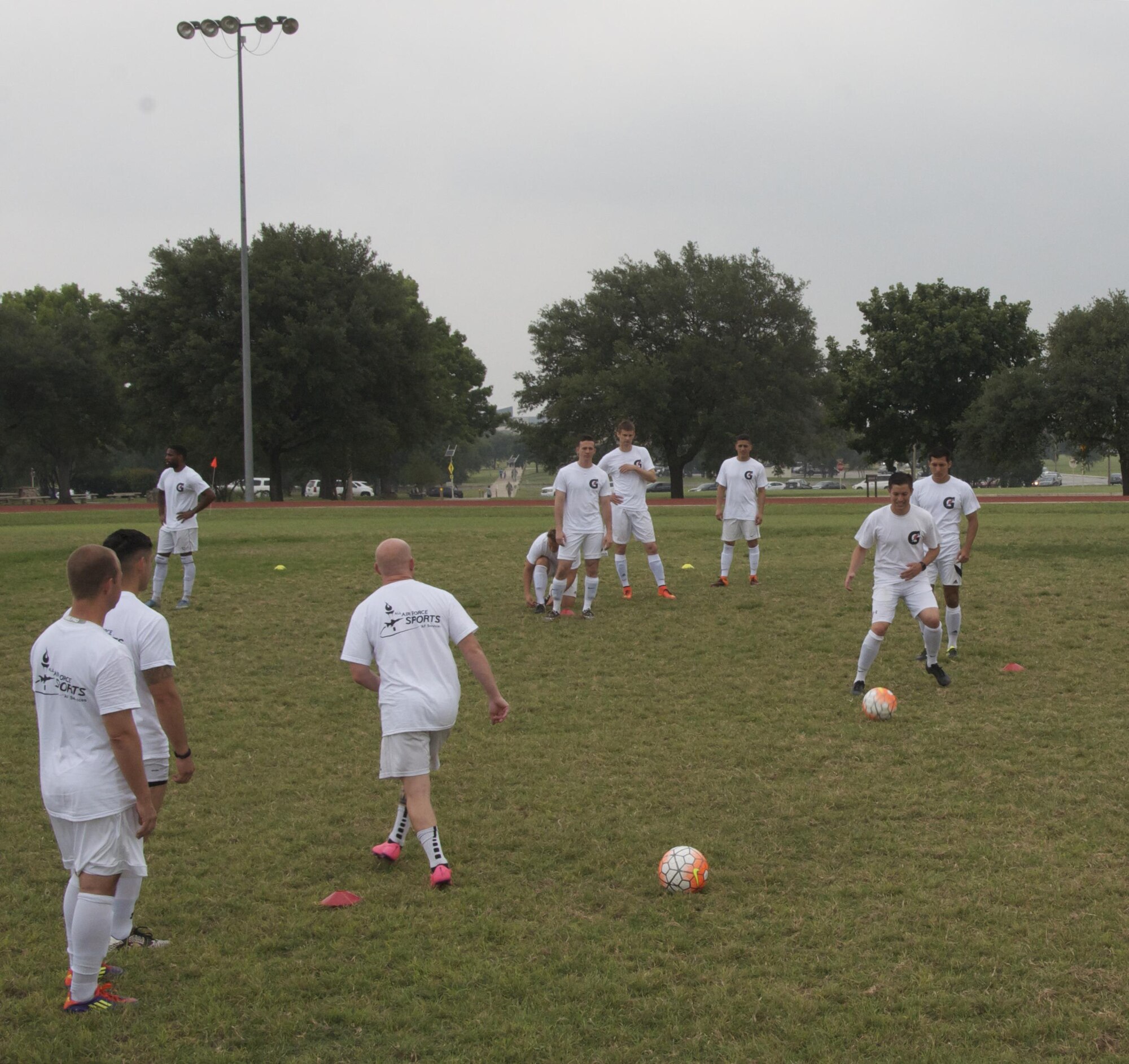 The All-Air Force men's soccer team practices April 29 at Joint Base San Antonio-Lackland, Texas. The team trained three times a day during the 2 1/2-week training camp. (U.S. Air Force photo/Steve Warns/released)