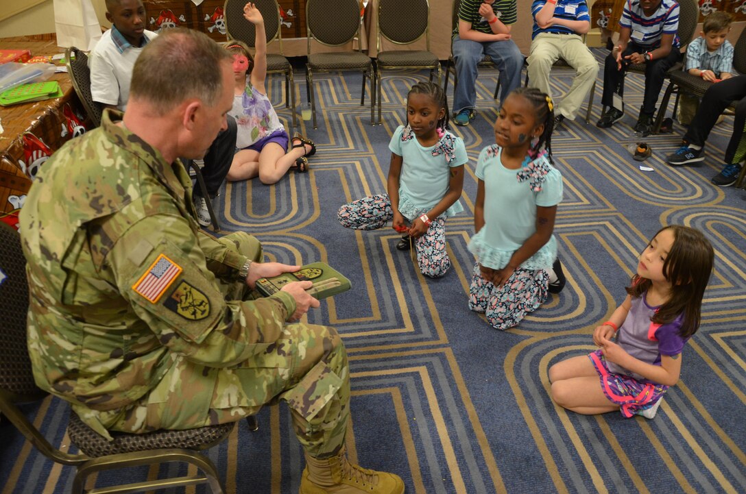 Maj. Gen. Patrick J. Reinert, 88th RSC commanding general, explains the patches on his senior leader’s book to a classroom of military children during the Yellow Ribbon Event in Bloomington, Minn., May 7. “Soldier Speak”, an 88th RSC Yellow Ribbon Program highlight, allows children of military families an opportunity to ask a Soldier questions and share concerns, challenges and stories. The children ranged in age from six to twelve years old. Reinert met the children’s curiosity with openness and honesty, sharing his own personal experiences and encouraging the children to talk about their concerns as well as their accomplishments. Reinert also presented each military child with an “All American Hero” award during a children’s program in honor of their unique strengths and sacrifices.