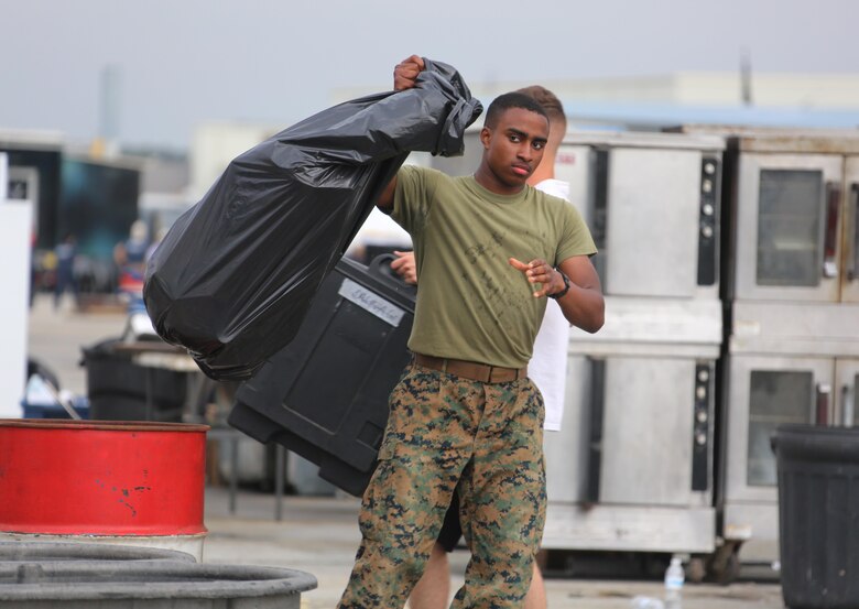 Marines, Sailors and civilians disassemble set-ups on the flight line following the 2016 Marine Corps Air Station Cherry Point Air Show -- "Celebrating 75 Years' at MCAS Cherry Point, N.C. The air show celebrated MCAS Cherry Point and 2nd Marine Aircraft Wing’s 75th anniversaries and featured 40 static displays, 17 aerial performers and a concert.