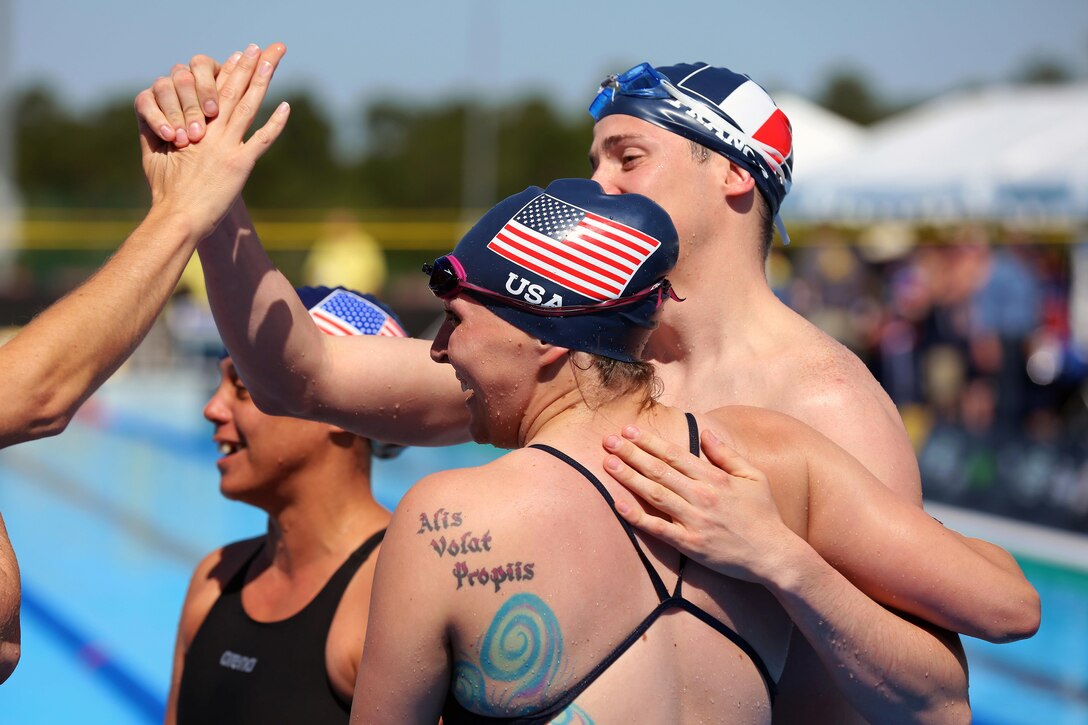 U.S. Army veteran Randi Gavell, foreground, embraces a fellow wounded warrior from France after competing in the swimming preliminaries at the 2016 Invictus Games in Orlando, Fla., May 7, 2016. Gavell is a military police officer. Army photo by Sgt. Jason Edwards