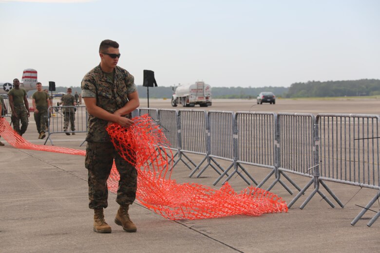 Marines, Sailors and civilians disassemble set-ups on the flight line following the 2016 Marine Corps Air Station Cherry Point Air Show -- "Celebrating 75 Years' at MCAS Cherry Point, N.C. The air show celebrated MCAS Cherry Point and 2nd Marine Aircraft Wing’s 75th anniversaries and featured 40 static displays, 17 aerial performers and a concert.