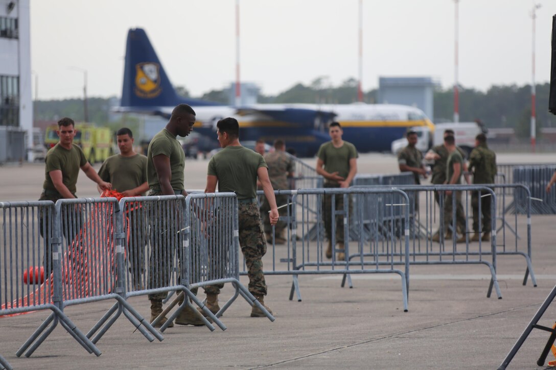 Marines, Sailors and civilians disassemble set-ups on the flight line following the 2016 Marine Corps Air Station Cherry Point Air Show -- "Celebrating 75 Years' at MCAS Cherry Point, N.C. The air show celebrated MCAS Cherry Point and 2nd Marine Aircraft Wing’s 75th anniversaries and featured 40 static displays, 17 aerial performers and a concert.