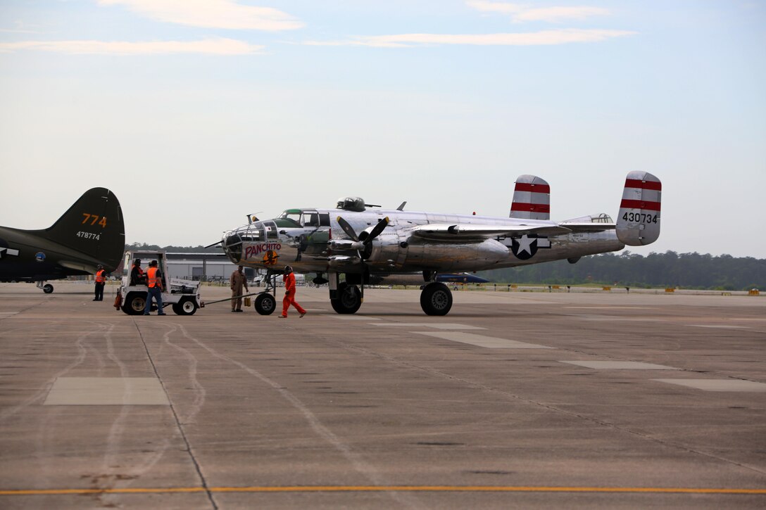 Marines, Sailors and civilians disassemble set-ups on the flight line following the 2016 Marine Corps Air Station Cherry Point Air Show -- "Celebrating 75 Years' at MCAS Cherry Point, N.C. The air show celebrated MCAS Cherry Point and 2nd Marine Aircraft Wing’s 75th anniversaries and featured 40 static displays, 17 aerial performers and a concert.