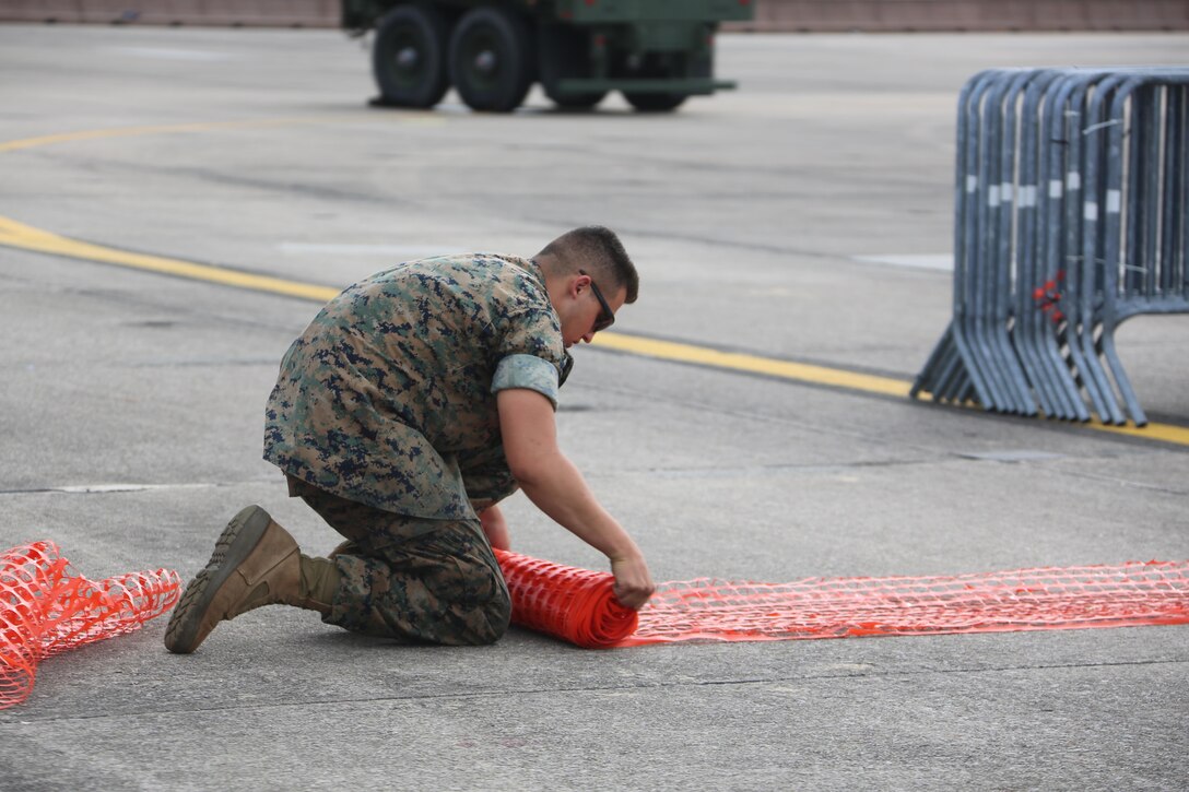 Marines, Sailors and civilians disassemble set-ups on the flight line following the 2016 Marine Corps Air Station Cherry Point Air Show -- "Celebrating 75 Years' at MCAS Cherry Point, N.C. The air show celebrated MCAS Cherry Point and 2nd Marine Aircraft Wing’s 75th anniversaries and featured 40 static displays, 17 aerial performers and a concert.