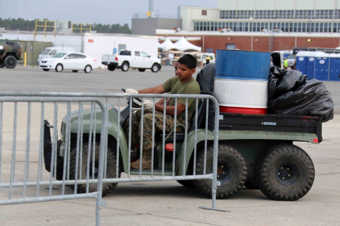 Marines, Sailors and civilians disassemble set-ups on the flight line following the 2016 Marine Corps Air Station Cherry Point Air Show -- "Celebrating 75 Years' at MCAS Cherry Point, N.C. The air show celebrated MCAS Cherry Point and 2nd Marine Aircraft Wing’s 75th anniversaries and featured 40 static displays, 17 aerial performers and a concert.