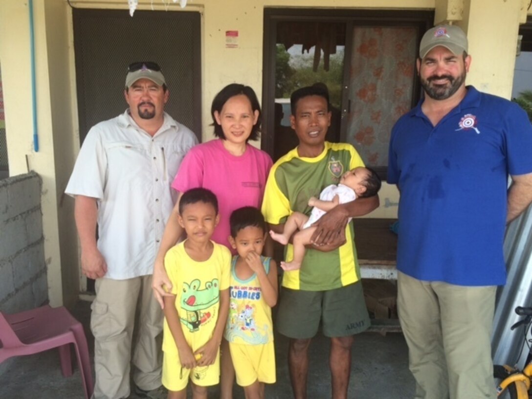 U.S. Army Alaska civilian facility operations specialists Antonio Granillo, far left, and Daniel Staicer, far right, pose with the Ariola family in the Philippines while supporting exercise Balikatan 2016. Philippine Army Sgt. Jehsie Ariola's wife needed an emergency blood transfusion, and thanks to the blood donated by Staicer, she is now healthy. Courtesy photo