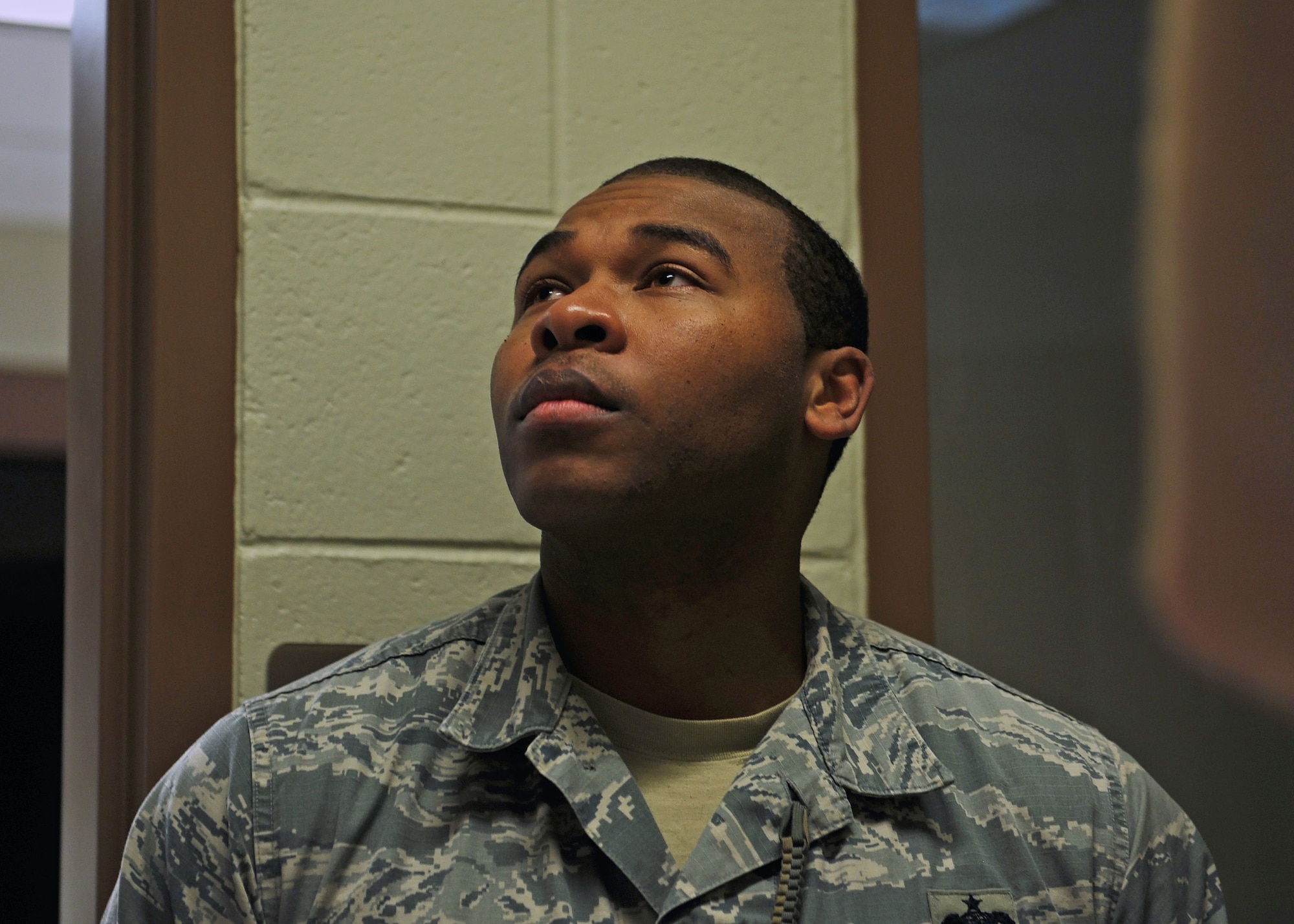 Staff Sgt. Ali Williams, 27th Special Operations Security Forces Squadron confinement NCO in-charge, reads over the rules of confinement at the 27th SOSFS compound April 13, 2016 at Cannon Air Force Base, N.M. Upon arriving at the confinement section for in-processing, inmates are required to read the rules aloud for the NCOIC to hear. (U.S. Air Force photo/Staff Sgt. Whitney Amstutz)