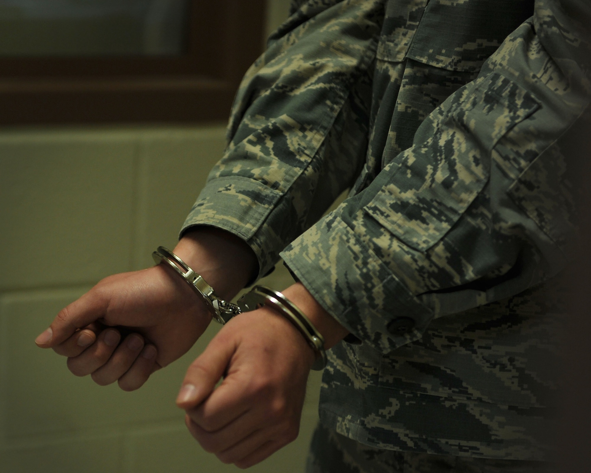 A simulated inmate stands with his hands cuffed, reciting the rules of confinement April 13, 2016 at the 27th Special Operations Security Forces Squadron compound at Cannon Air Force Base, N.M. In addition to reading the rules aloud for the confinement NCO in-charge to hear, inmates are given a rulebook and a test to ensure they understand expectations and may be held accountable for infractions. (U.S. Air Force photo/Staff Sgt. Whitney Amstutz)