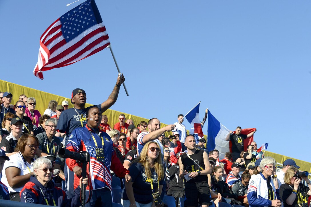 Fans show their support for U.S. swimmers in preliminary competitions at the 2016 Invictus Games in Orlando, Fla., May 7, 2016. Air Force photo by Staff Sgt. Carlin Leslie