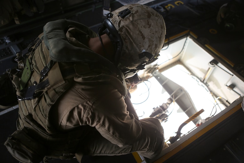 Cpl. Aaron Culler, a crew chief with Marine Medium Tiltrotor Squadron (VMM) 165, observes the Bambi bucket from an MV-22B Osprey and waits to release the water over a designated drop zone during the 2016 Wildland Firefighting Exercise aboard Marine Corps Base Camp Pendleton, Calif., May 5. The exercise was a multiaircraft operation with both ground and air units working together for maximum firefighting efforts. (U.S. Marine Corps photo by Lance Cpl. Harley Robinson/Released)