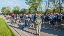 National Air and Space Intelligence Center personnel show support for their "Burpee Challenge" team members during the first NASIC run of the season, May 6, 2016. The center participates in runs during the spring and summer  in an effort to foster positive teamwork among members and boost morale. (U.S. Air Force photo/Tech. Sgt. Eunique P. Thomas)