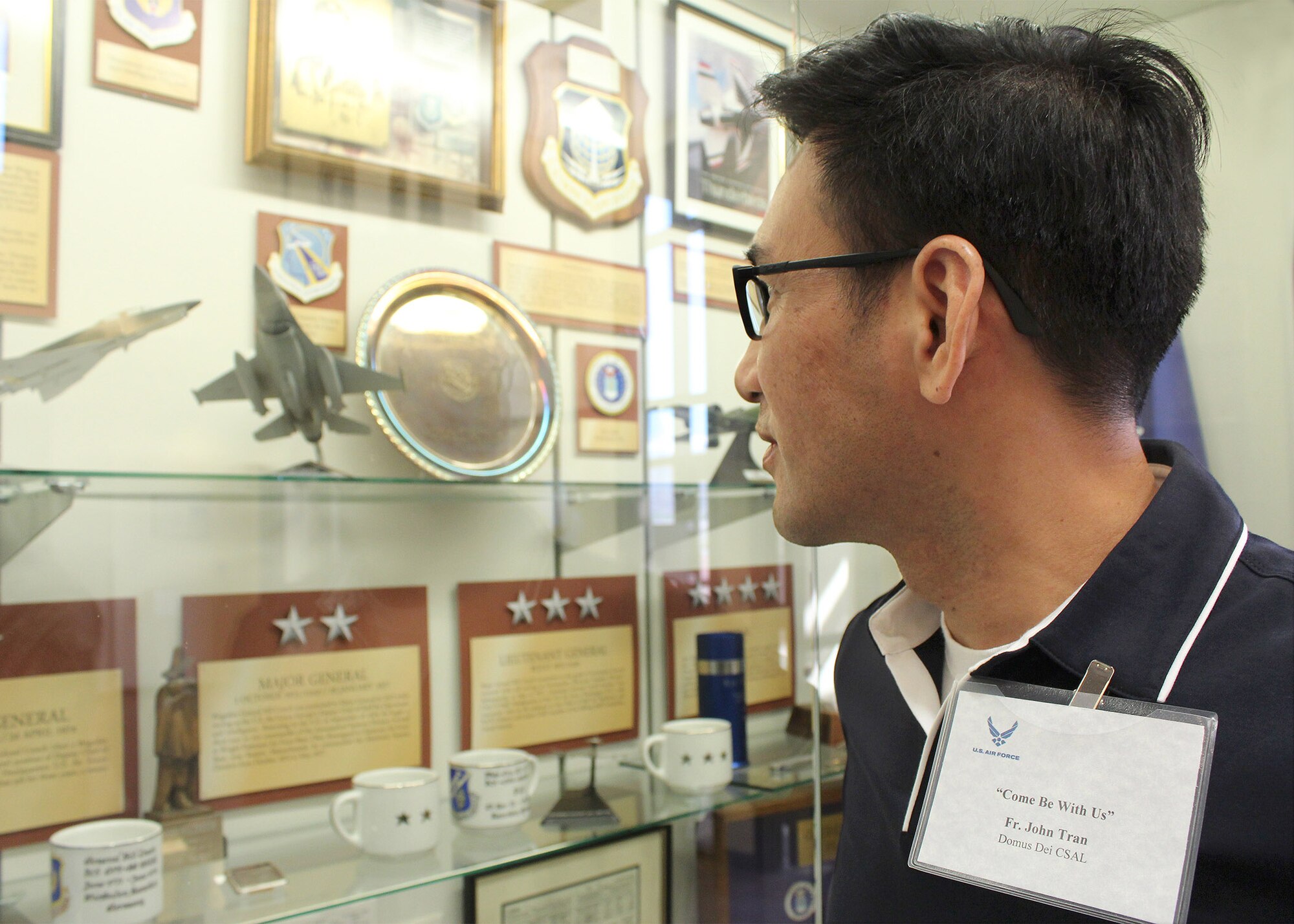 Father John Tran, of the Domus Dei Clerical Society of Apostolic Life in New Orleans, views personal mementos of the late Gen. Wilbur “Bill” Creech on display at the 432nd Wing headquarters at Creech Air Force Base, Nev. Tran was one of six civilian Catholic priests who recently participated in the recent Air Force Recruiting Service’s “Come Be With Us Familiarization Tour” at Creech and Nellis AFB, Nev. The priests got a first-hand look at the Air Force chaplain way of life. (U.S. Air Force photo/Dale Eckroth)