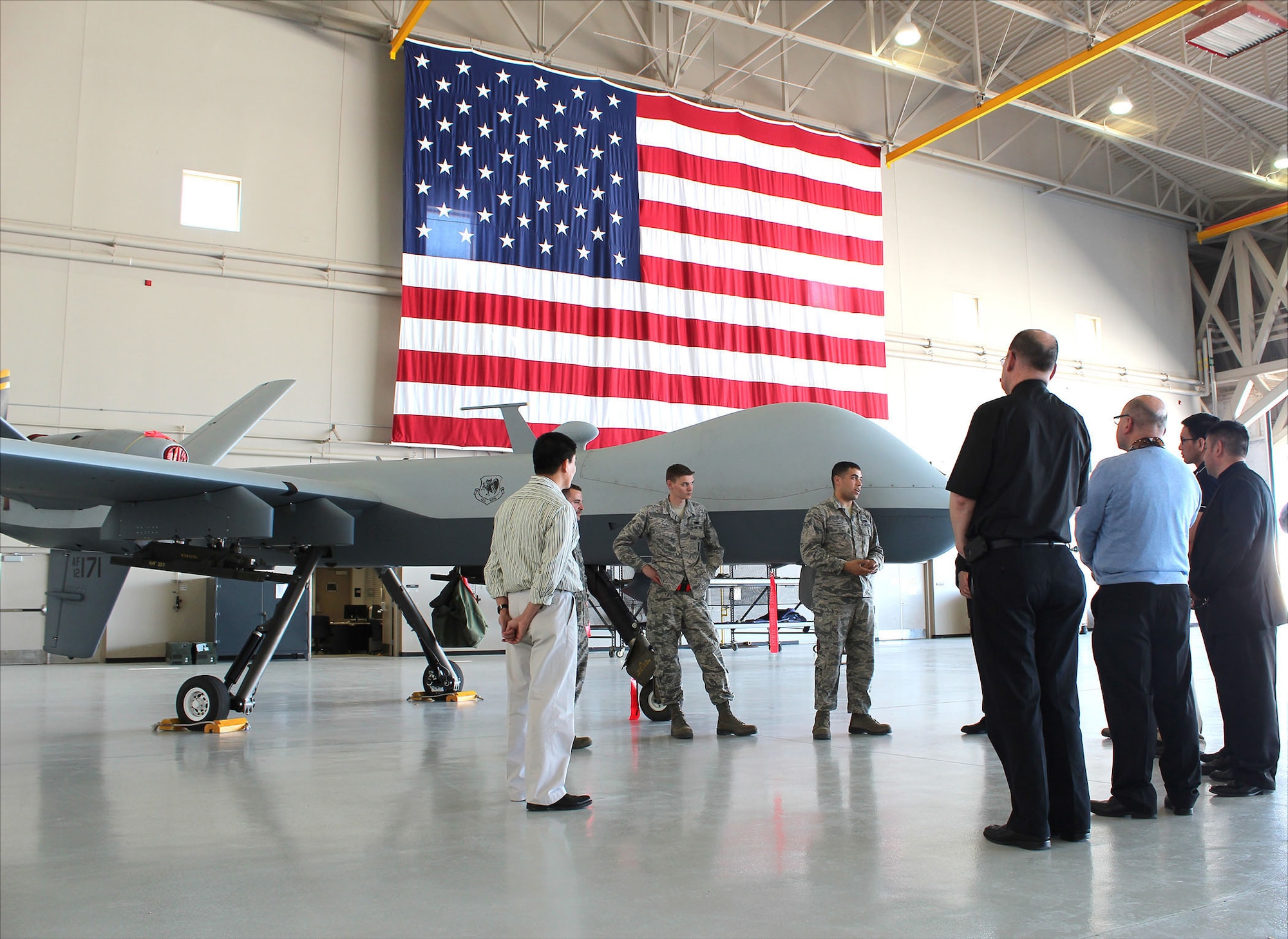 Crewmembers explain the characteristics of the MQ-9 Reaper to visiting priests during Air Force Recruiting Service’s “Come Be With Us Familiarization Tour” at Creech Air Force Base, Nev. (U.S. Air Force photo/Dale Eckroth)