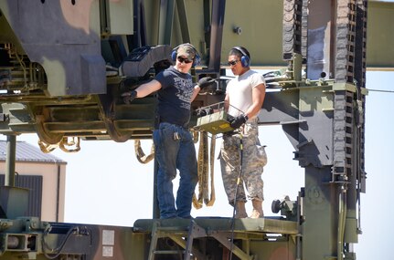 88th Regional Support Command Equipment Concentration Site - 67 personnel, Heath Thornsen (left) trains a Soldier on the operation of a Dry Support Bridge, a new-generation tactical military bridging system, at the soon to be established Draw Yard at ECS-67 on Fort McCoy, Wis., May 5.